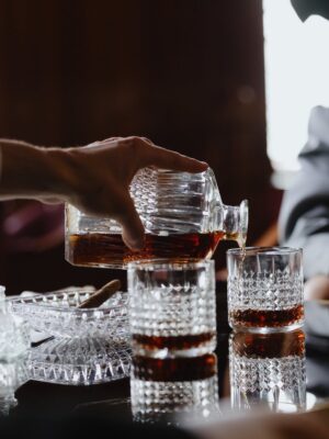 A Person Pouring Drinks at a Table