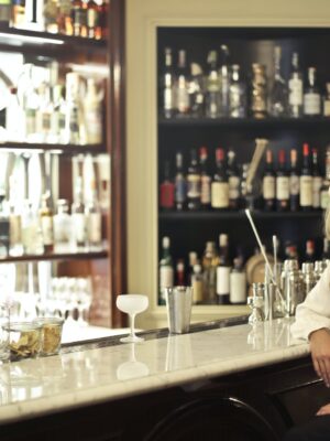 Woman in White Long Sleeve Leaning In Counter Table